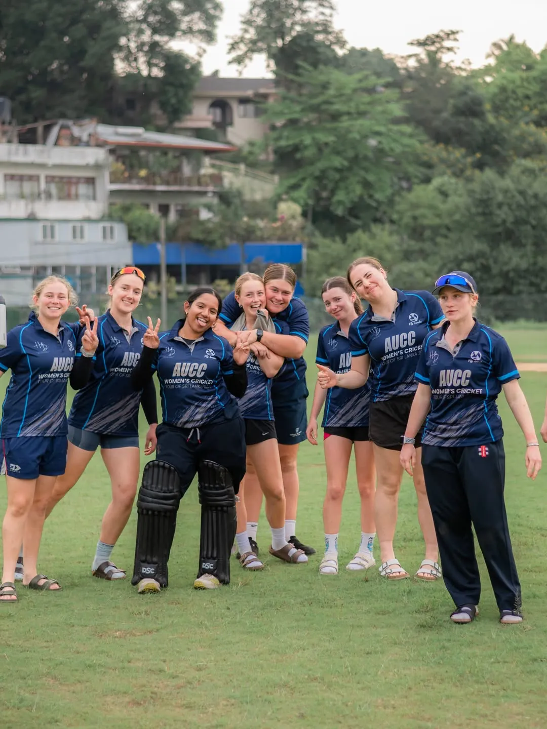 Auckland University players laughing together on the outfield after a match